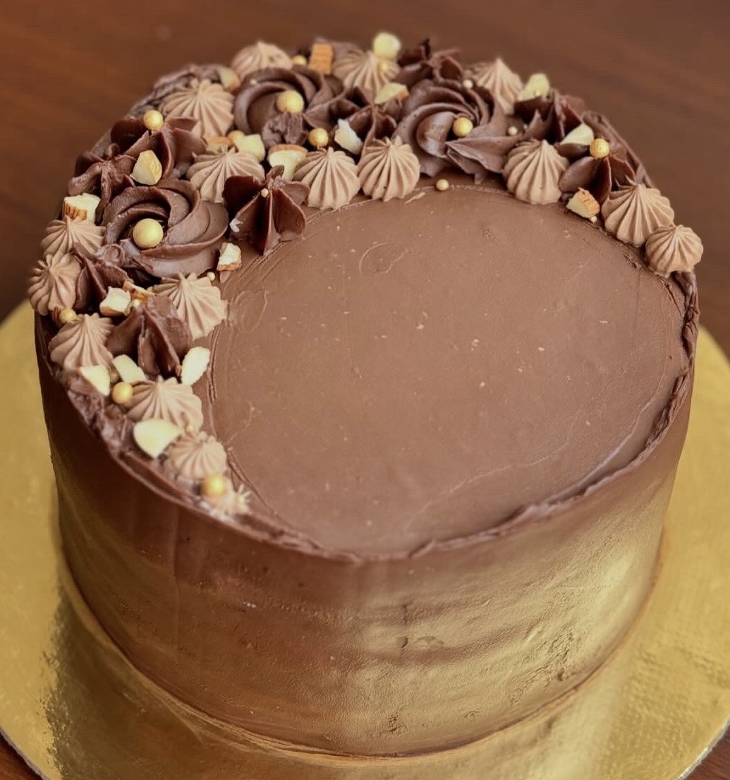 Chocolate Layer Cake — rich chocolate ganache cake with piped chocolate rosettes, meringue kisses and gold pearl accents